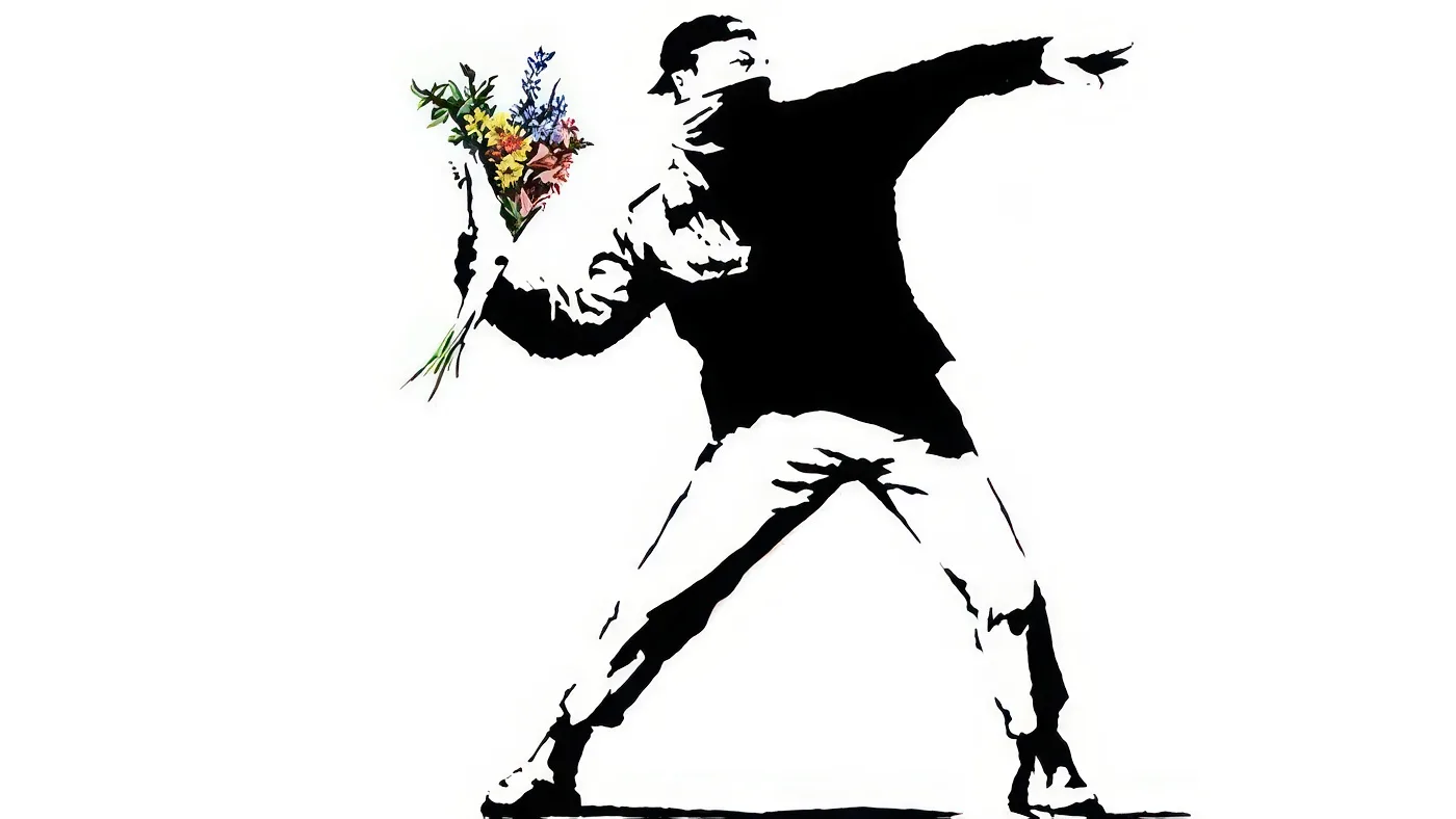 A stencil artwork by the elusive street artist Banksy depicts a masked figure in a poised throwing position, clutching a bouquet of colorful flowers instead of a projectile. The figure wears casual clothing and a cap, scarf ensemble. Bright red, yellow, and blue flowers contrast against the plain white background.