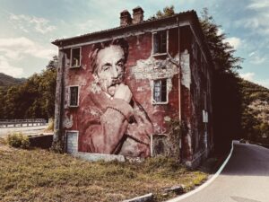 Eduardo De Filippo July 2023 by Street Artist Beast. Eduardo De Filippo embedded in the texture of an abandoned wall, a presence rooted in cultural memory and neglected places.