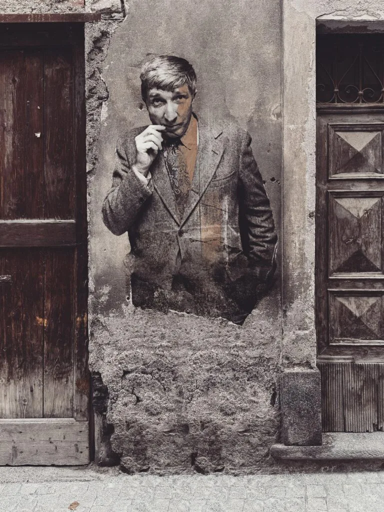 John Updike August 2025 by Street Artist Beast. John Updike surfacing from a worn façade, a portrait of literary memory resisting disappearance.